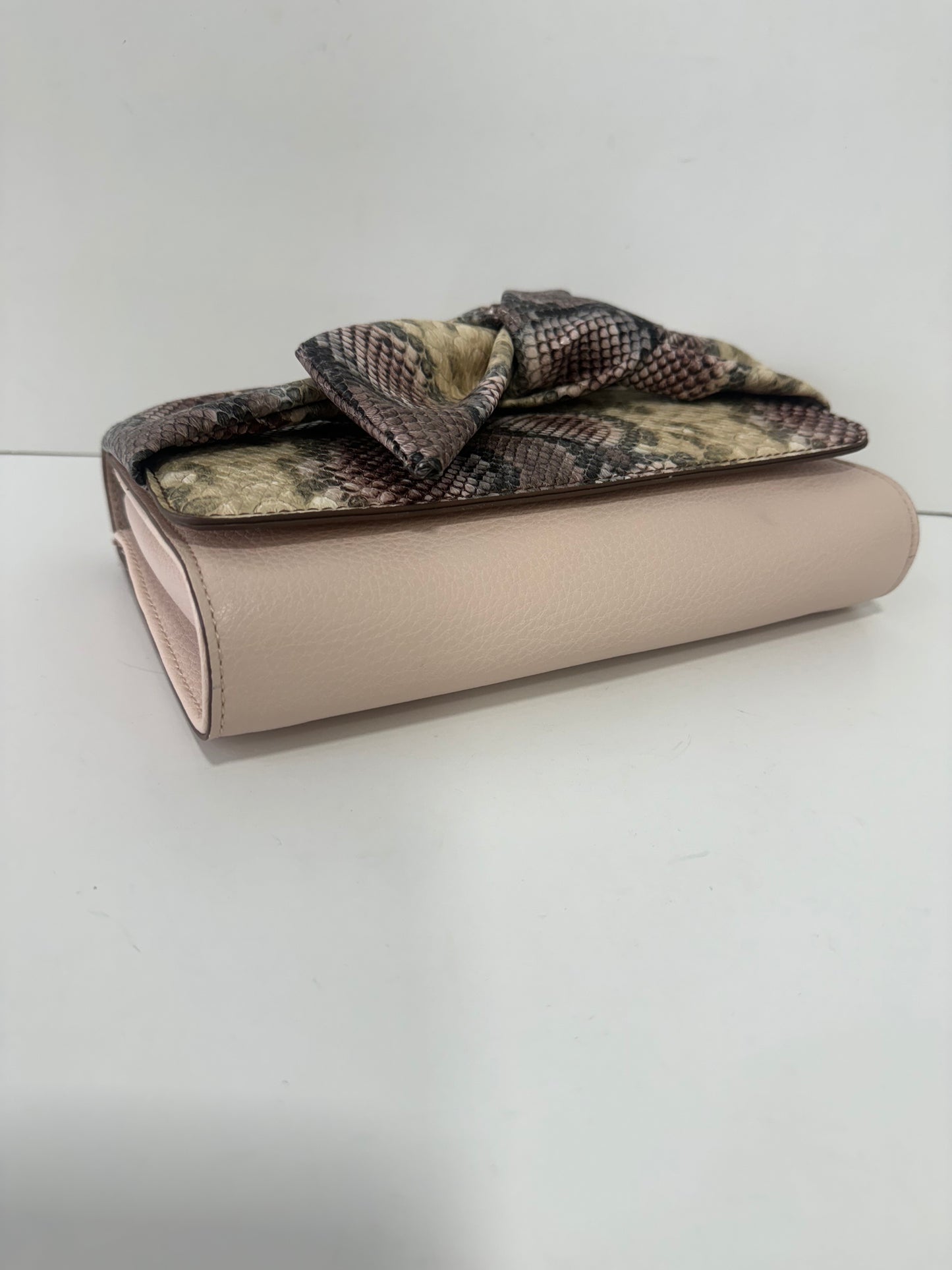 Pink snake textured clutch with bow