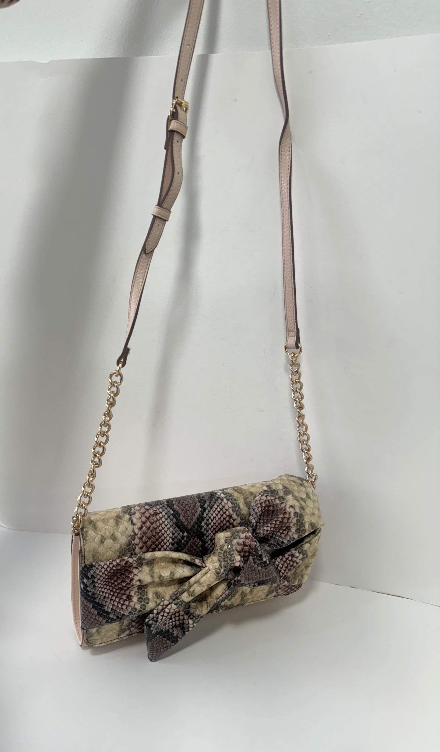 Pink snake textured clutch with bow